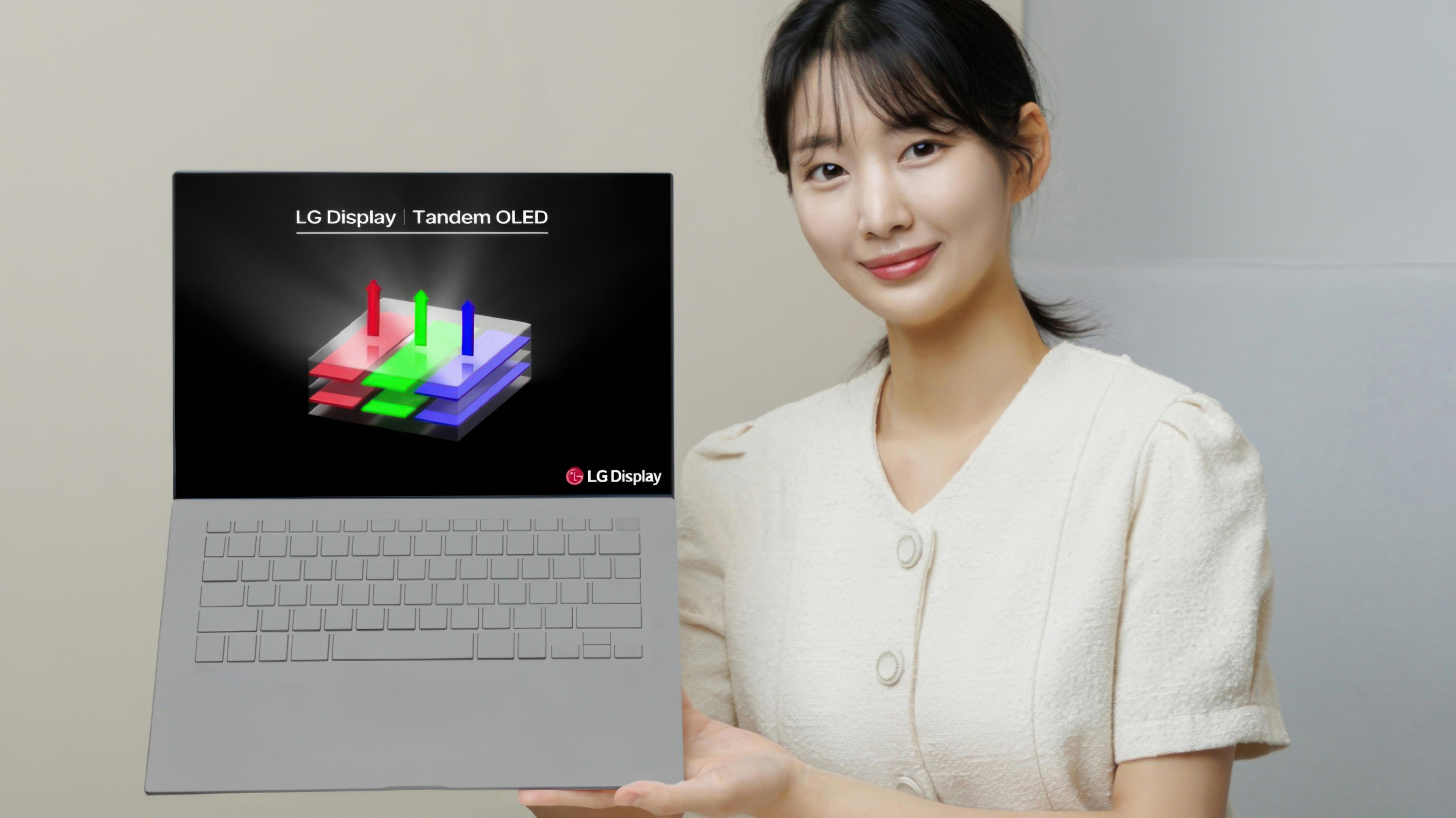 LG introduces Tandem OLED a woman holding a laptop